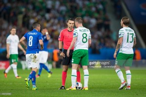 LILLE, FRANCE - JUNE 22: Referee Ovidiu Hategan (Romania) talks to Republic of Ireland's James McCarthy during the UEFA Euro 2016 Group E match between Italy and Republic of Ireland at Stade Pierre-Mauroy on June 22 in Lille, France. (Photo by Craig Mercer/CameraSport via Getty Images)